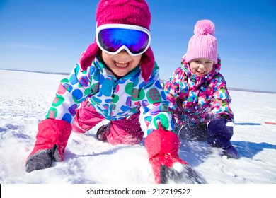 Group Of Children Playing On Snow In Winter Time