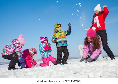 Group Of Children Playing On Snow In Winter Time