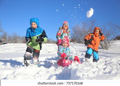 Group Of Children Playing On Snow In Winter Time