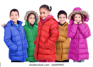 Group of children posing in colorful winter coats isolated in white