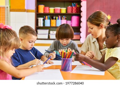 Group Of Children In Preschool Or Kindergarten Doing Creative Painting And Drawing