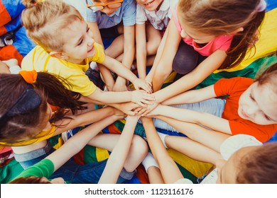 Group of children putting their hands together