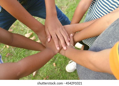 group of children putting their hands together. Team work or Kids experience concept.
