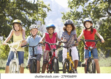 Group Of Children Riding Bikes In Countryside