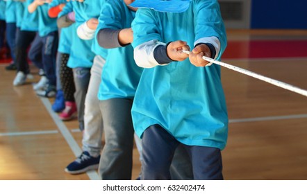 Group of children at ropepulling contest at school - Powered by Shutterstock