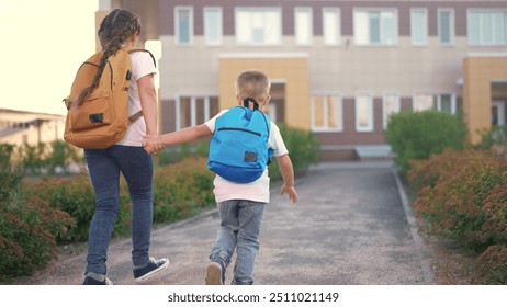 A group of children running around in backpacks at school. Backpack happy boy concept. Kids are back to school. A group of children running back to school with backpacks lifestyle. - Powered by Shutterstock