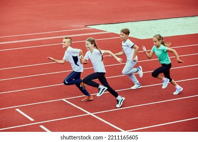 Group of children running on treadmill at the stadium or arena. Little fit boys and girls in sportswear training as athletes outdoor. Concept of sport, fitness, achievements, studying, goals, skills - Shutterstock ID 2211165605