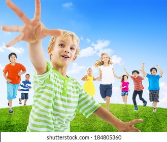 Group Of Children Running Towards The Camera