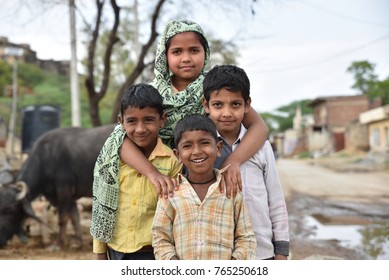 Group of children from rural India smiling and having good time together away from the hustle of urban jungle