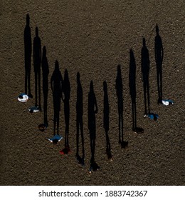 A Group Of Children Stand On The Road, Resulting In Shadows, Top View.2020