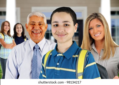 Group Of Children Standing In Front Of Their School With Teachers