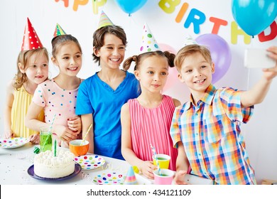 Group of children taking selfie at birthday party - Powered by Shutterstock