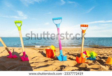 Group of children's beach toys on sunny day