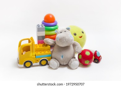 Group Of Childrens Toys On A White Background. Constructor, Pyramid, Ball And Soft Toys For Children's Development