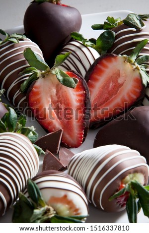 group of chocolate covered strawberries on white plate and light background, sliced chocolate covered strawberry, valentines day dessert, romantic, food gift