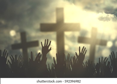 Group Of Christian People Hands Praying Together With Three Cross Symbol And Bright Sunbeam On The Sky