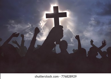 Group of christian people praying to Jesus christ with dramatic sky background