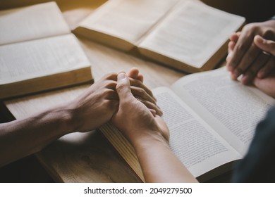 Group of christian people reading and study bible in home and pray together.Group of people holding hands praying worship god.Diverse religious shoot. - Shutterstock ID 2049279500
