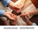 Group of Christians are congregants join hands to pray and seek the blessings of God, the Holy Bible. They were reading the Bible and sharing the gospel. Bible study. devotional. copy space. 