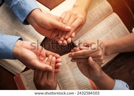 Group of Christians are congregants join hands to pray and seek the blessings of God, the Holy Bible. They were reading the Bible and sharing the gospel. Bible study. devotional. copy space. 