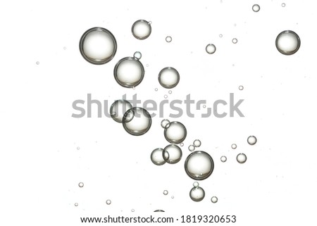 A group of clear bubbles isolated over a white surface.
