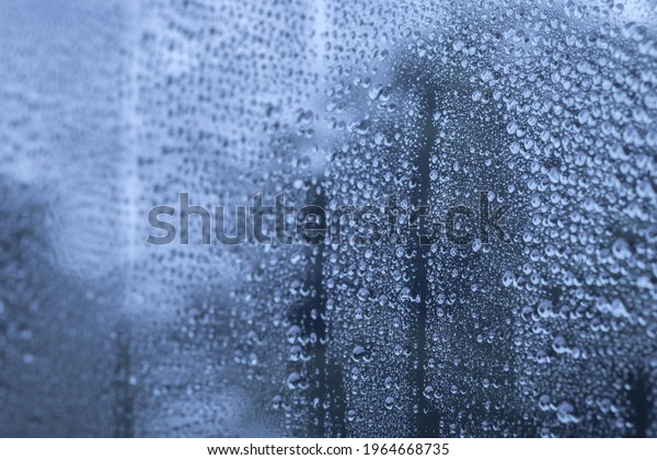 Group of clear rain drops or droplets after hart raining\
on window car mirror. Background with copy space for natural and\
environment wallpaper or meteorology concept. Selective focus. \
