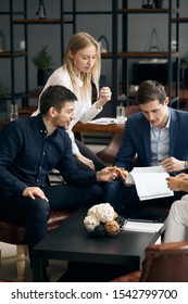 Group Of Clever Business People Reading A Document In The Office With Modern Interior. Close Up Photo. Paperwork. Teamwork