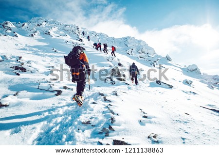 A group of climbers ascending a mountain in winter