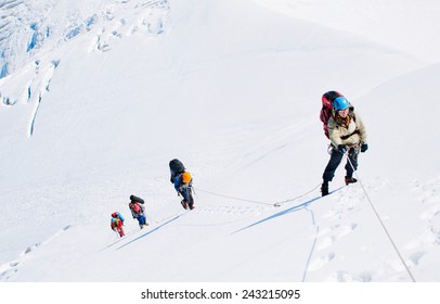 Group Of  Climbers Reaching The Summit