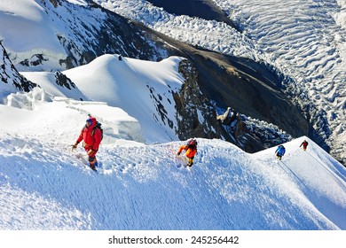 Group Of  Climbers Reaching The Summit