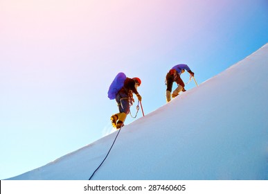 Group Of  Climbers Reaching The Summit