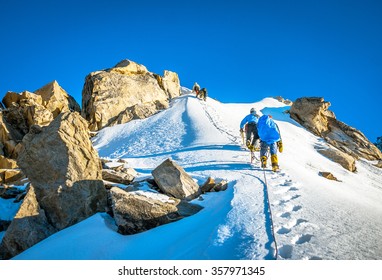 Group Of Climbers Reaching The Summit