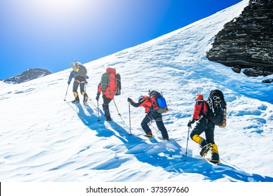 Group Of Climbers Reaching The Summit