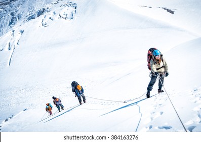 Group Of Climbers Reaching The Summit. 