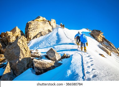 Group Of Climbers Reaching The Summit