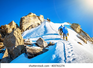 Group Of Climbers Reaching The Summit