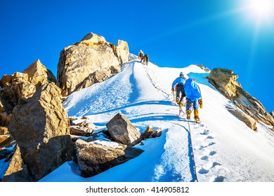 Group Of Climbers Reaching The Summit