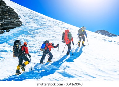 Group Of Climbers Reaching The Summit. Extreme Sport