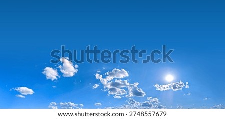 A group of clouds in the form of a wide panorama. Blue background with space for text and a light blue gradient. Violet Sky with Cloud Summer Spring Nature Light on Beautiful Natural sky Backdrop.