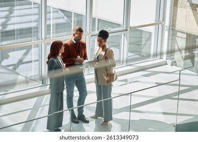 Group of colleagues cooperating while working on a computer in the office. Copy space.