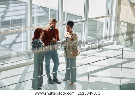 Group of colleagues cooperating while working on a computer in the office. Copy space.