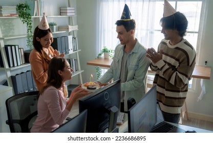 Group of colleagues surprises co-workers with birthday cake at work. - Powered by Shutterstock