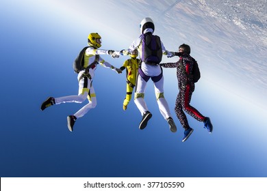 Group collects figure skydivers in freefall.