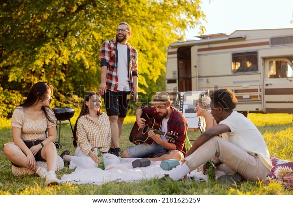 A group of college friends spend time together
singing surrounded by nature. A bearded middle-aged boy plays the
guitar. The good friends travel together in their beloved old
camper van.