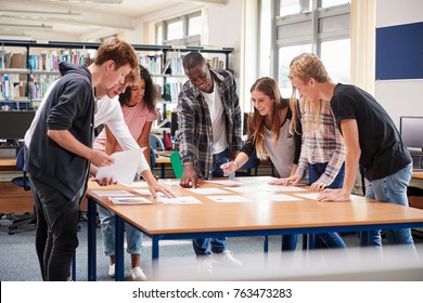 Group Of College Students Collaborating On Project In Library