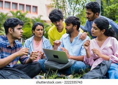 Group of college students discussing about project with team leader from laptop at college campus - concept of teamwork, ideas and collaboration - Powered by Shutterstock