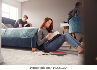 Group Of College Students In Shared House Bedroom Studying Together