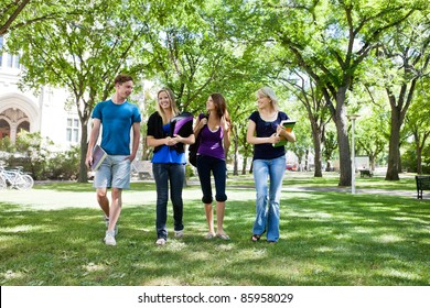 Group Of College Students Walking In Campus Ground