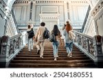 A group of college students walking up the stairs with backpacks on their shoulders. Motivation and academic success.Copy space.    