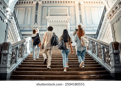 A group of college students walking up the stairs with backpacks on their shoulders. Motivation and academic success.Copy space.     - Powered by Shutterstock